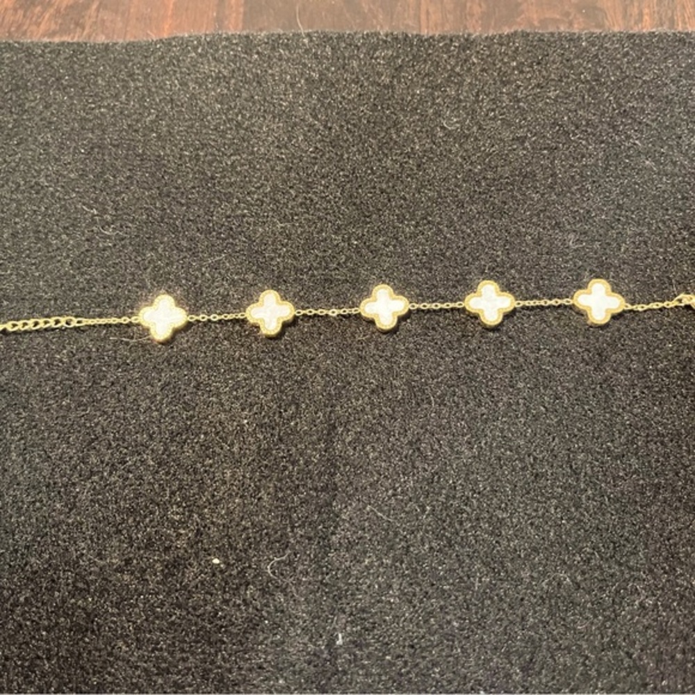 Gold tone white mother of pearl face clover bracelet